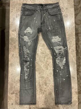 Waimea grey distressed paint-splattered skinny jeans .
